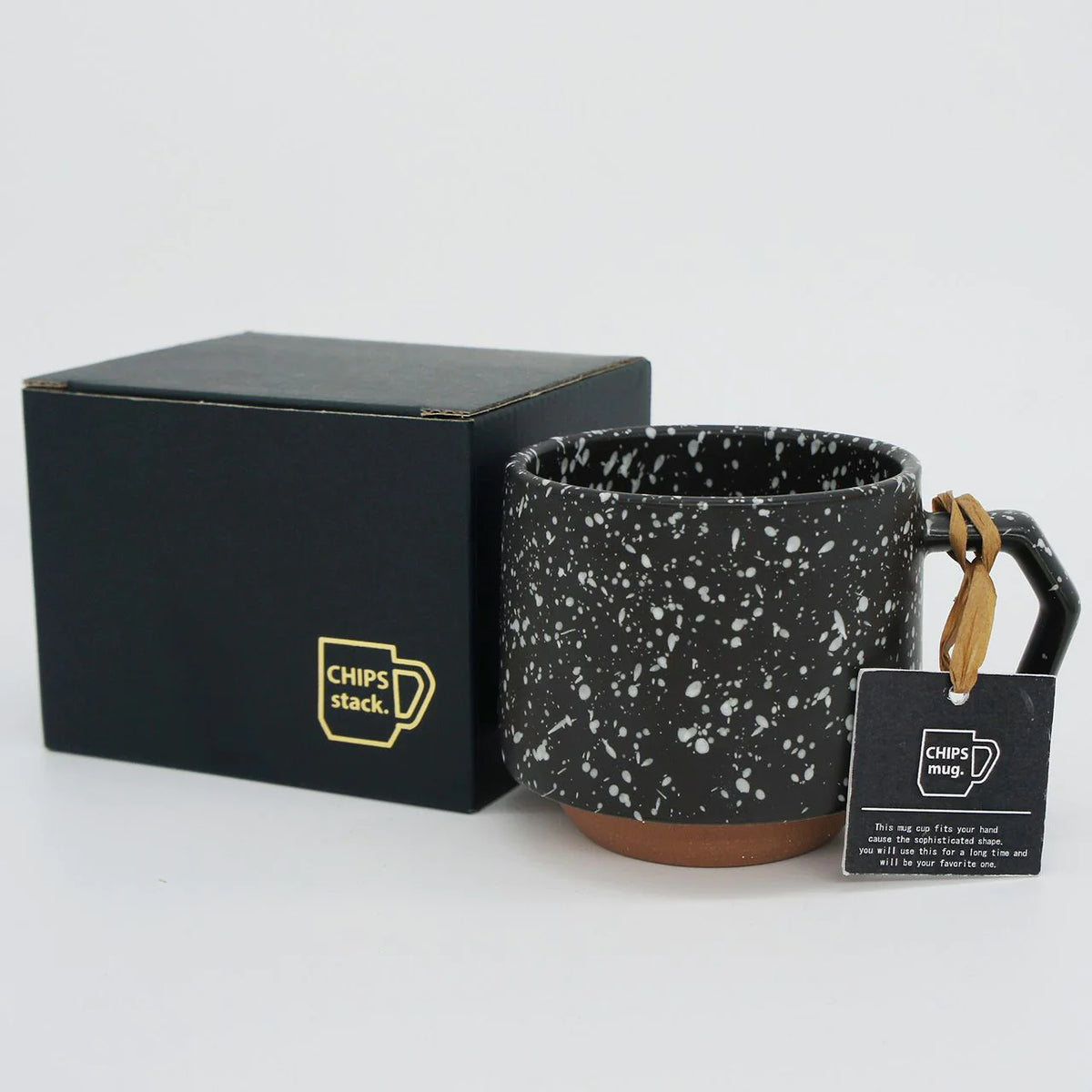 A Stacking Mug – Speckled Black made of porcelain, complete with a tag and packed in a black box by CHIPS Inc.
