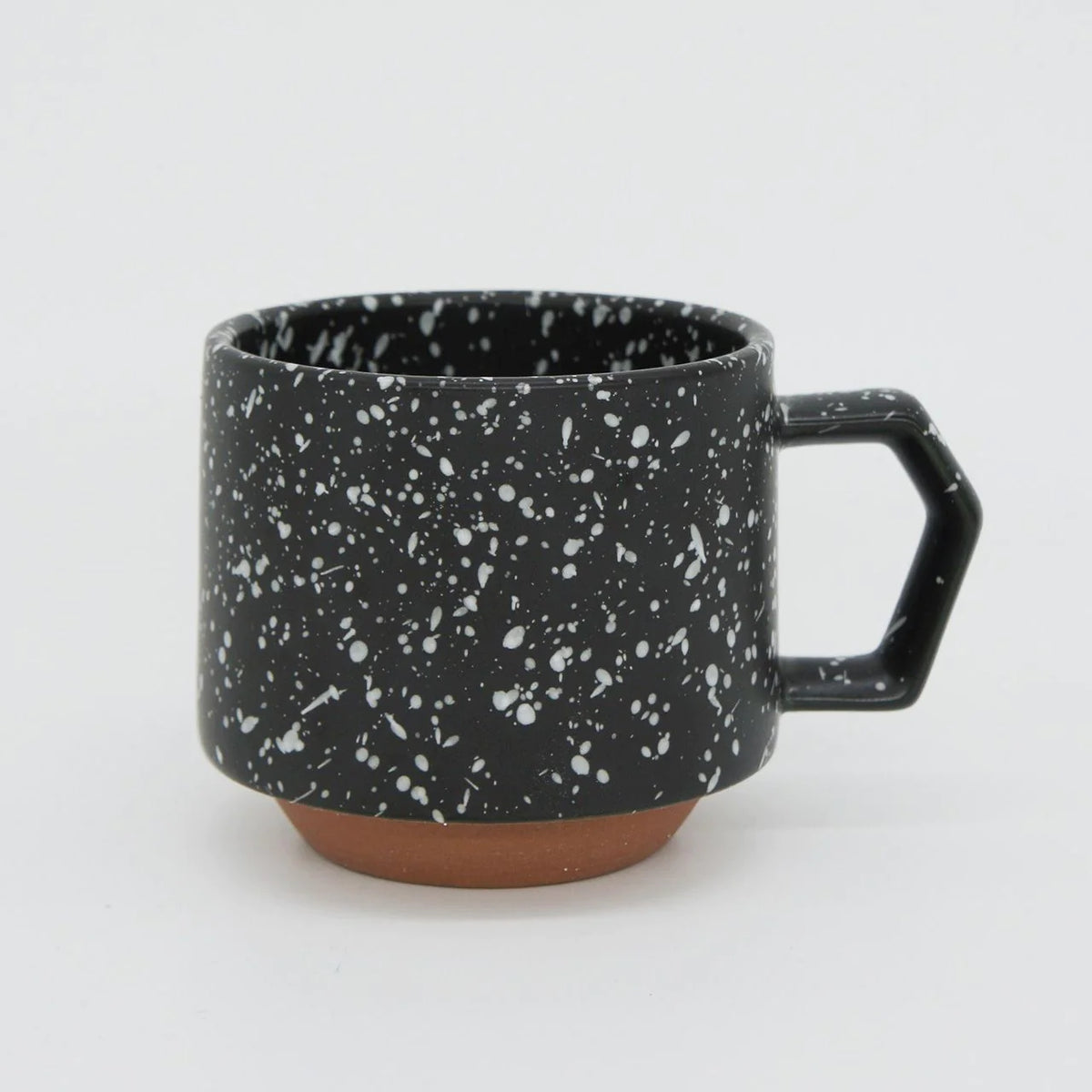 A Stacking Mug – Speckled Black made of porcelain with white speckles on it, manufactured by CHIPS Inc.