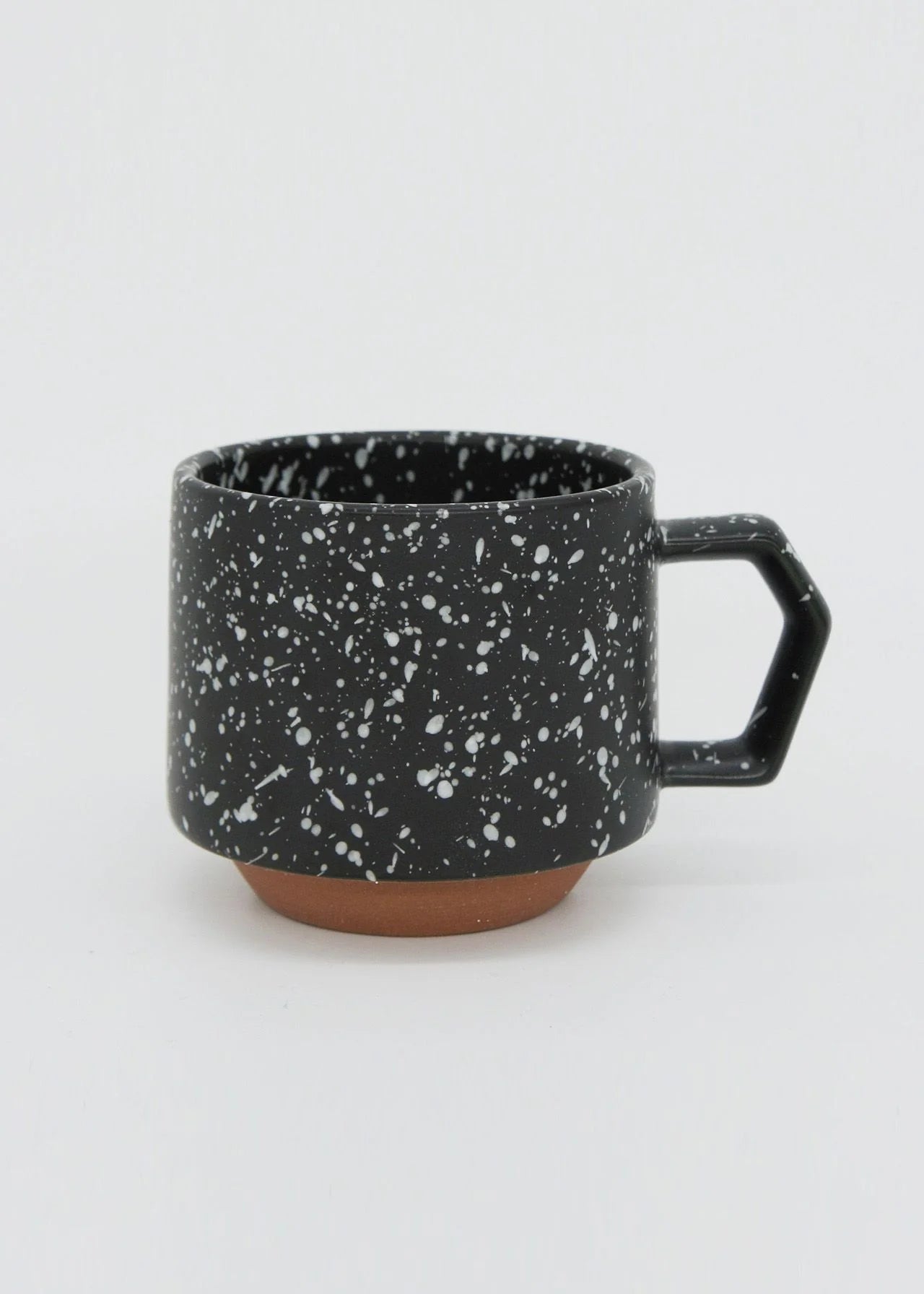 A CHIPS Inc. Stacking Mug – Speckled Black with white speckles on it.