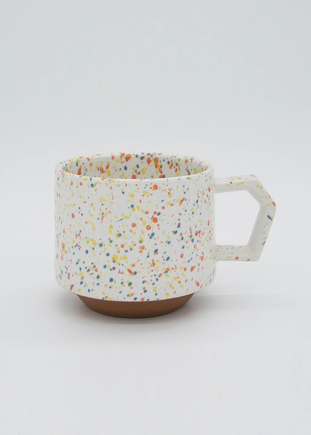 A Stacking Mug - Speckled White with multi colored speckles on it, made by CHIPS Inc.