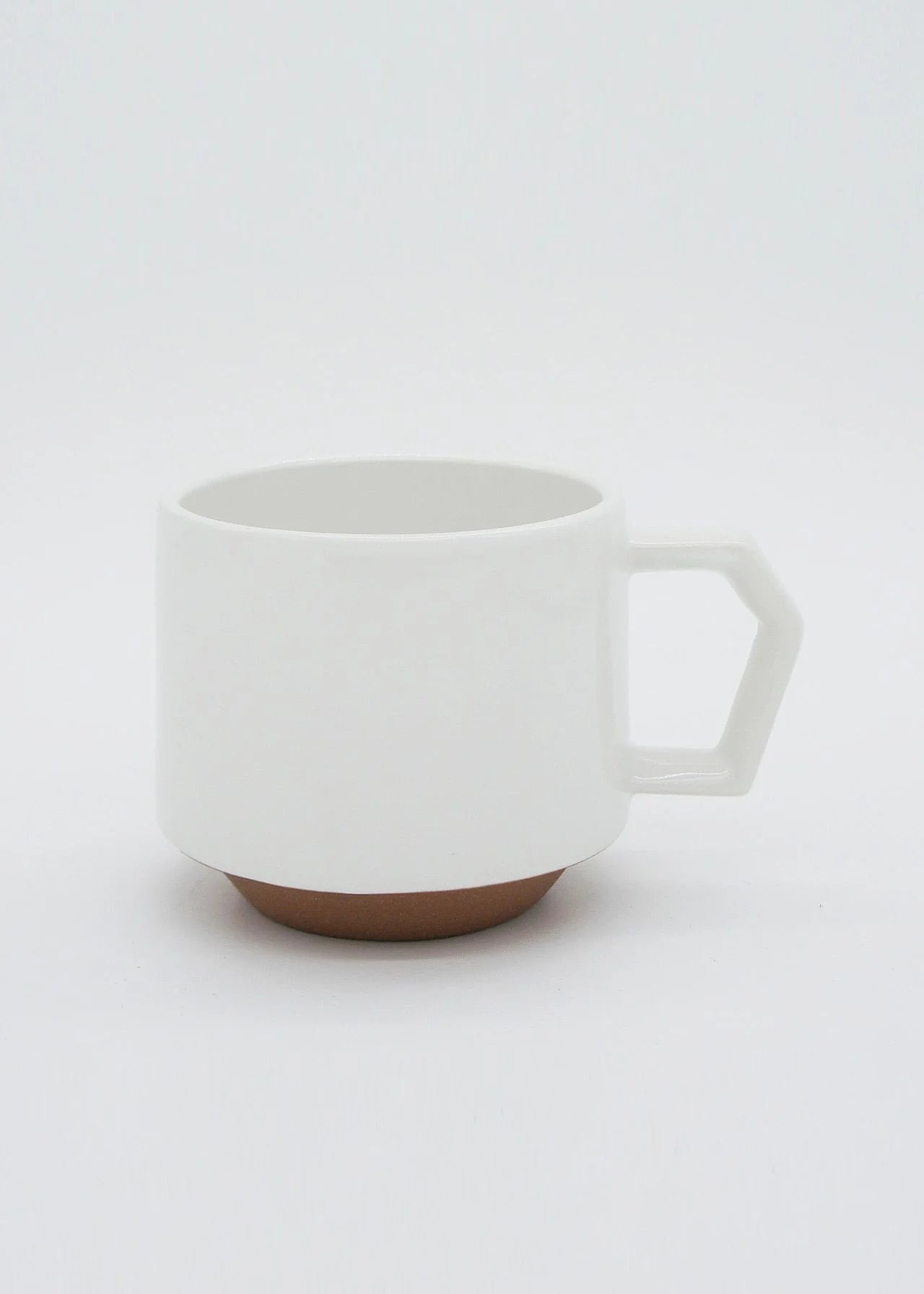 A stackable Stacking Mug – White with a brown handle on a white background by CHIPS Inc.