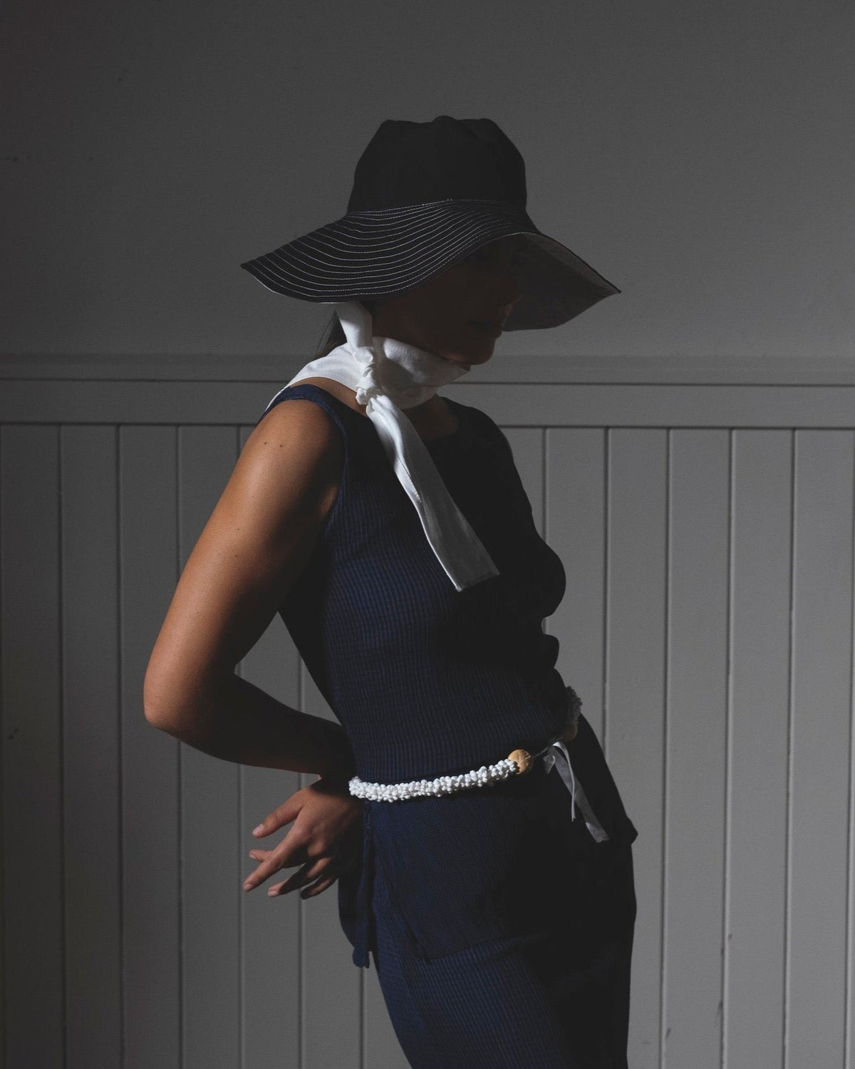 A woman wearing a Companion Broad Brim with Wide Ties – Monochromatic hat and dress for shade and sun protection.