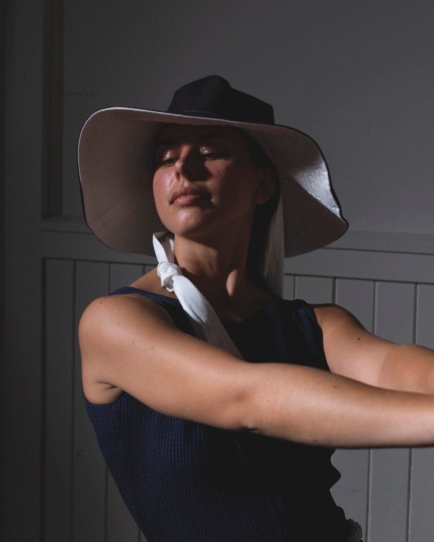A woman wearing a Companion Broad Brim with Wide Ties - Monochromatic hat for shade and protection.