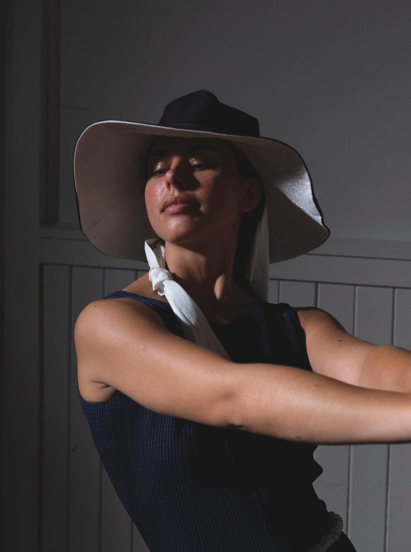 A woman wearing a Companion Broad Brim with Wide Ties - Monochromatic hat for shade and protection.