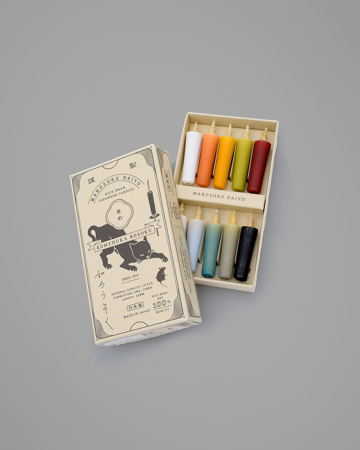 A box of Rice Wax Candles – Earth by Daiyo featuring illustrated outer packaging. The lid is open, showcasing eight colorful rice wax candles arranged in two rows, ideal for meditation and infusing any space with serenity.