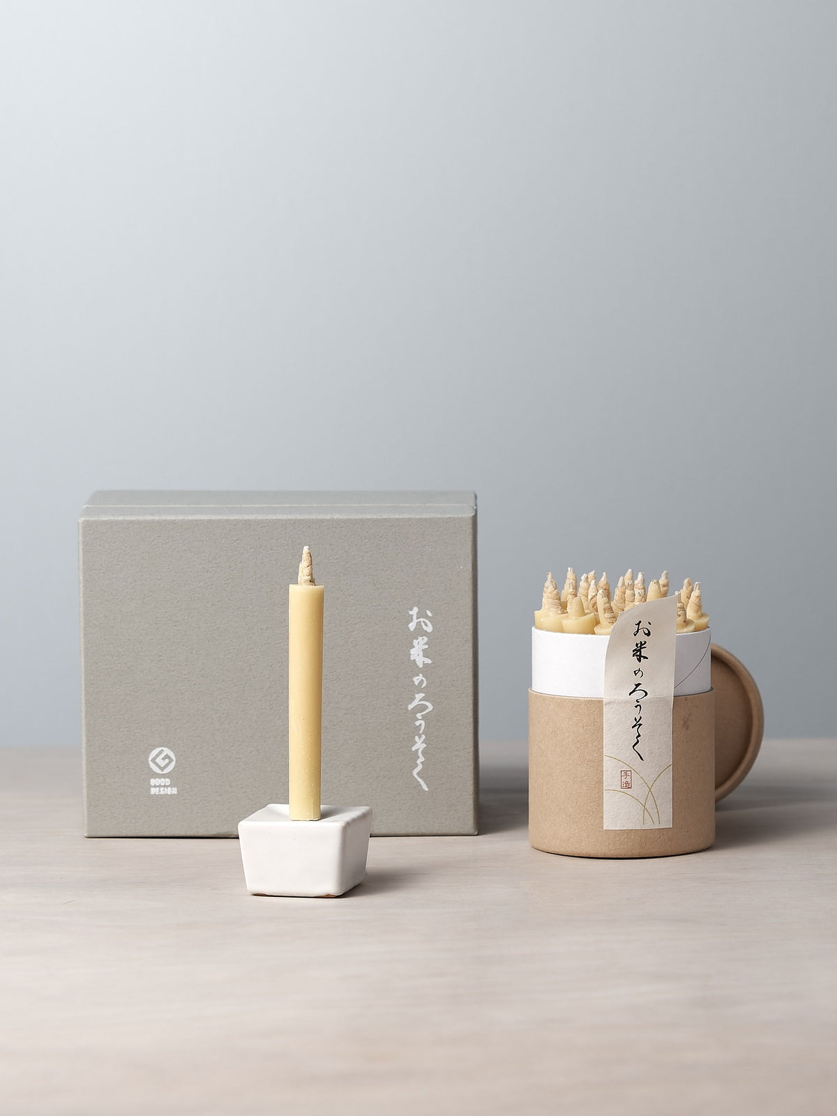 A Daiyo Rice Wax Candle &amp; Iron Stand Gift Box Set – 20pcs on a table.