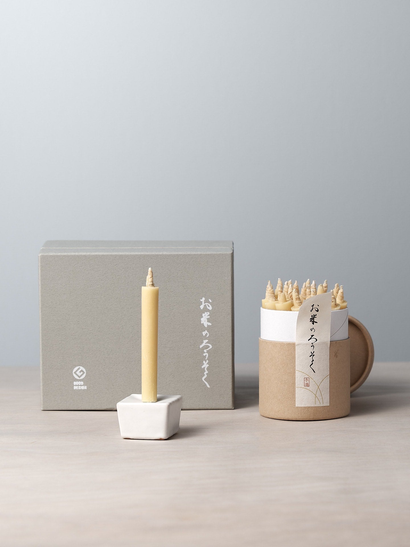 A Daiyo Rice Wax Candle & Iron Stand Gift Box Set – 20pcs on a table.