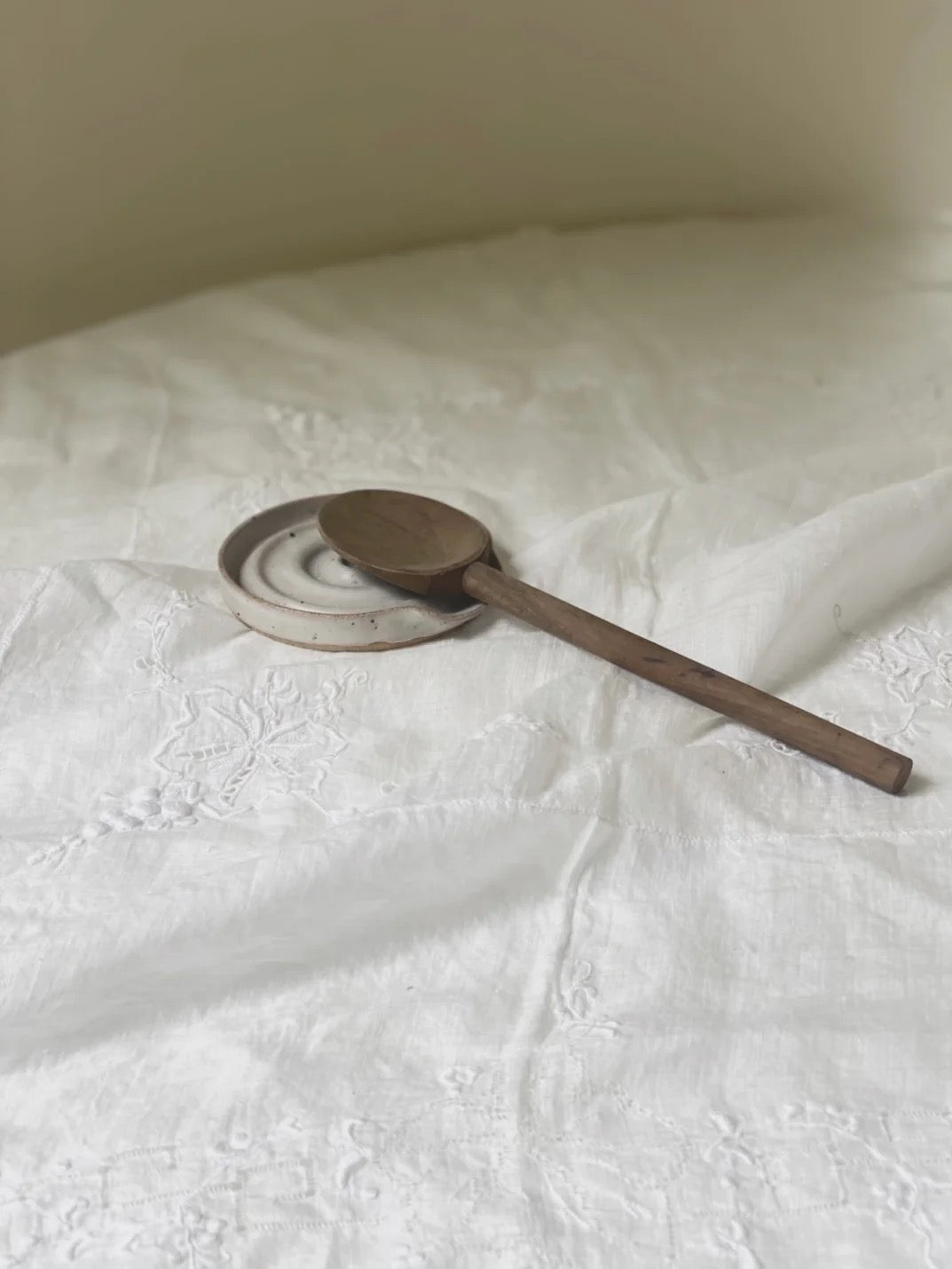 A deborah sweeney Spoon Rest – Cloud on top of a white sheet.