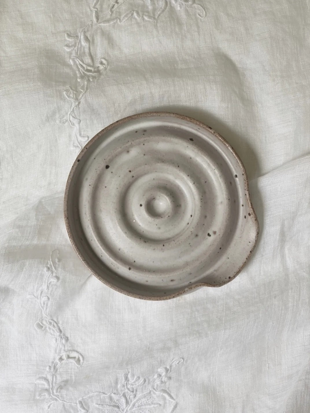 A handmade Spoon Rest - Cloud by deborah sweeney with a spiral pattern on it.