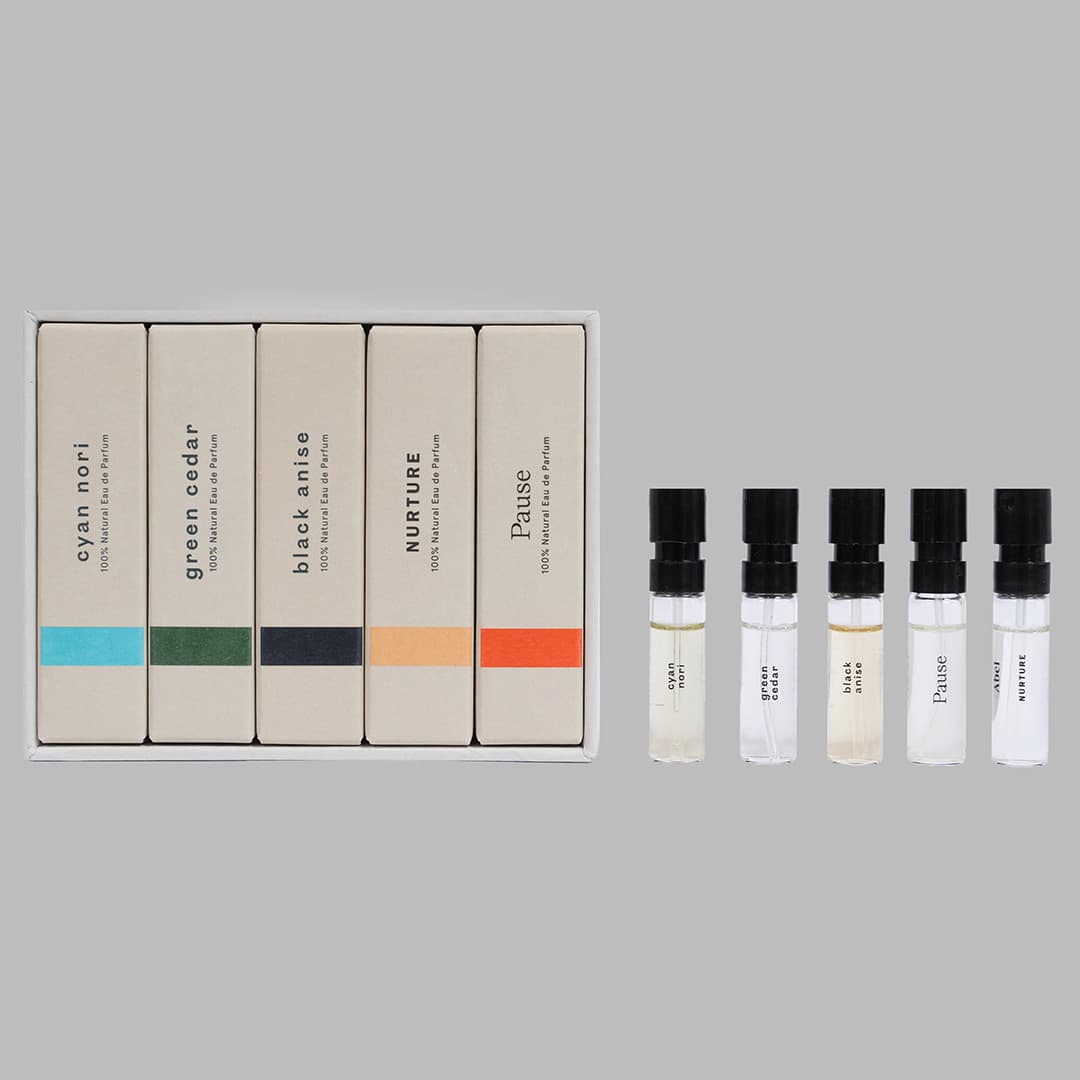 Discover the Abel fragrance Discovery Set – 5 most popular scents, featuring five boxed perfumes with labels reading &quot;cyan nori,&quot; &quot;green cedar,&quot; &quot;black maize,&quot; &quot;nurture,&quot; and &quot;pause.&quot; Each 100% natural scent comes with corresponding small sample vials for an immersive olfactory experience.