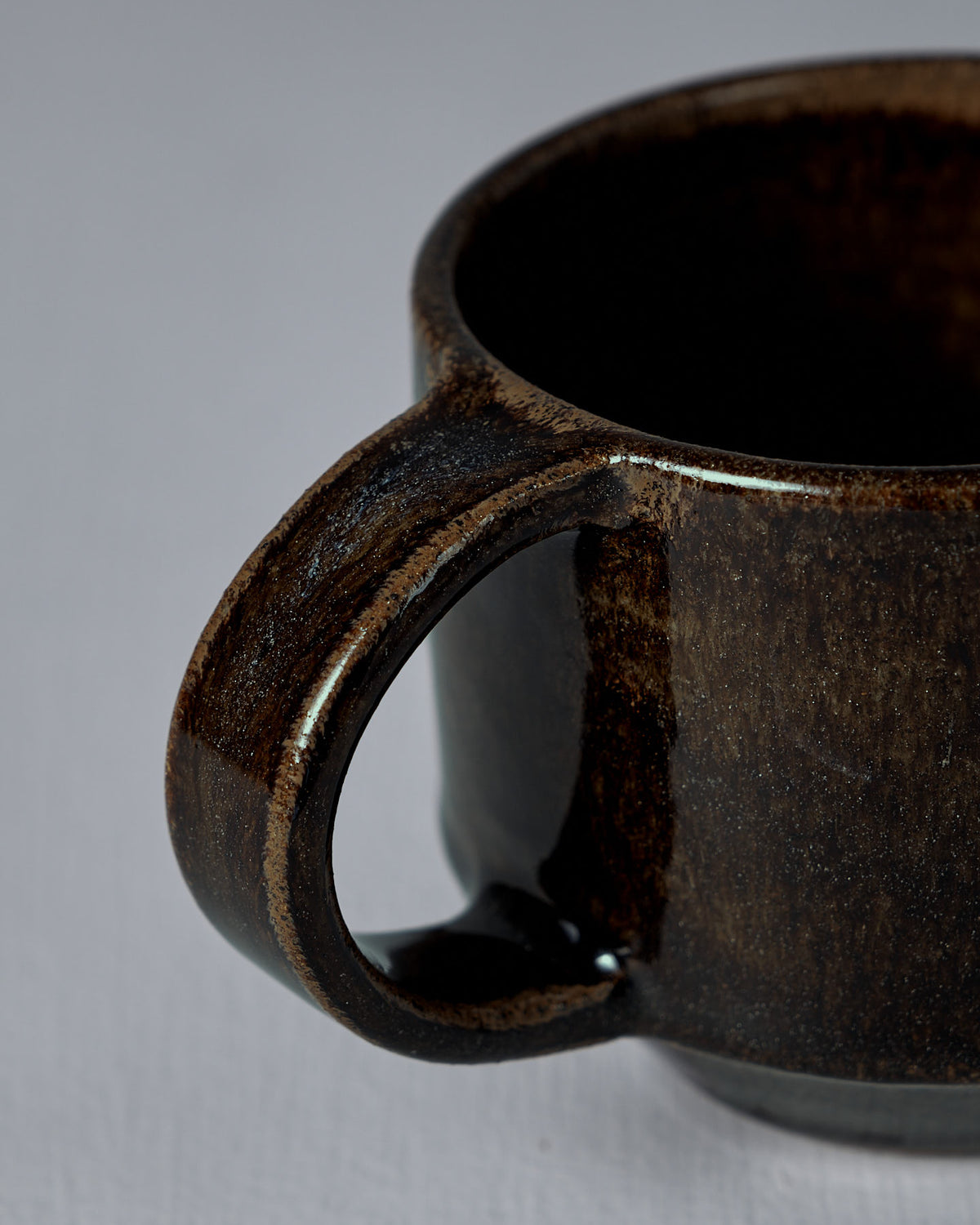 Close-up of the handle and rim of Studio Foon's Everyday Stacker Cup – Medium in Burnt Umber, shown against a plain light background.