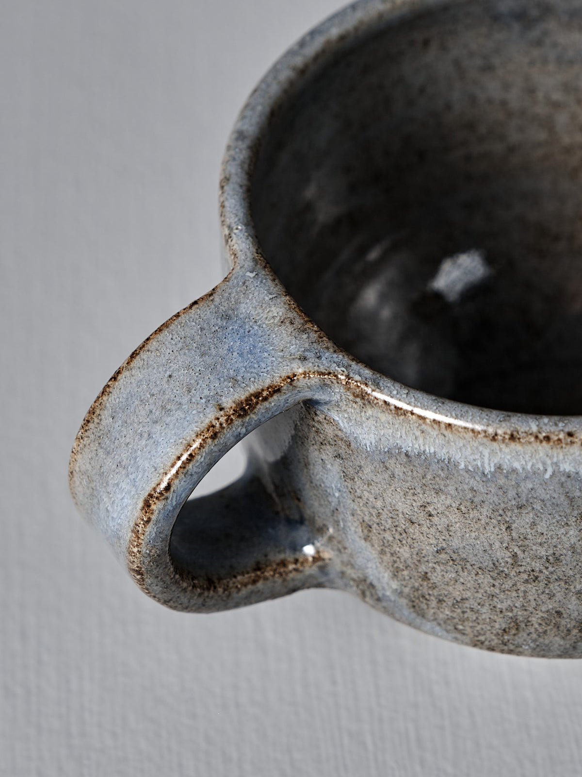 Close-up of Studio Foon’s Everyday Stacker Cup – Small in Indigo, featuring a handle and textured, speckled glaze—ideal for daily use or adding to your stackable cup collection.