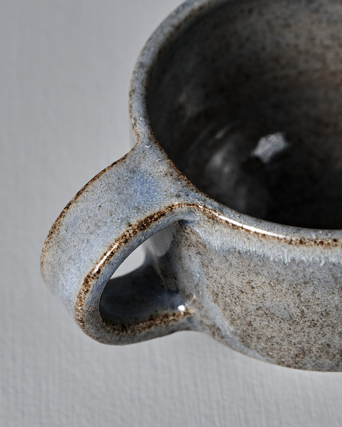 Close-up of Studio Foon’s Everyday Stacker Cup – Small in Indigo, featuring a handle and textured, speckled glaze—ideal for daily use or adding to your stackable cup collection.