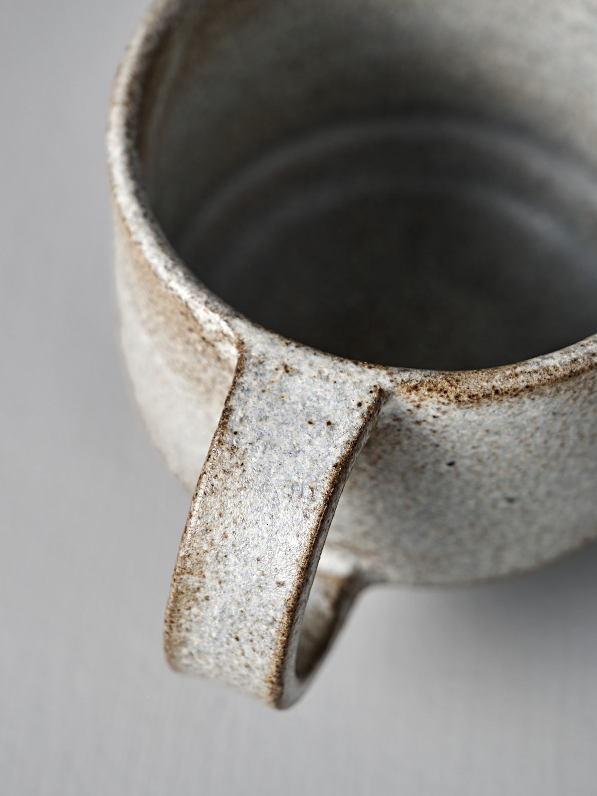 Close-up of Studio Foon’s Everyday Stacker Cup – Medium in Stone White, featuring a textured, speckled finish and large handle—ideal for enhancing your daily cup collection.