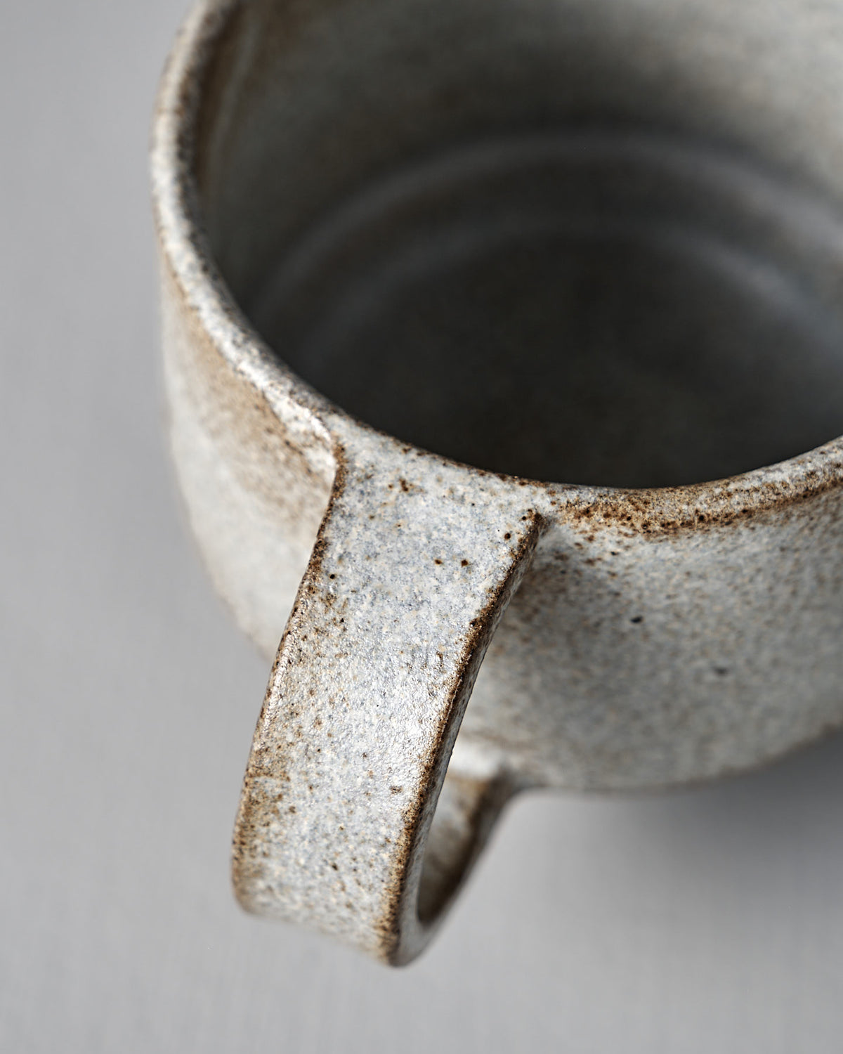 Close-up of Studio Foon’s Everyday Stacker Cup – Medium in Stone White, featuring a textured, speckled finish and large handle—ideal for enhancing your daily cup collection.
