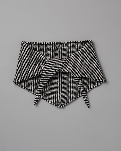 The Daisy Scarf – Black & Creme Stripe features a geometric knit pattern in black and creme, shown flat on a gray background with pointed ends overlapping. Dimensions: 97cm long x 22cm wide.