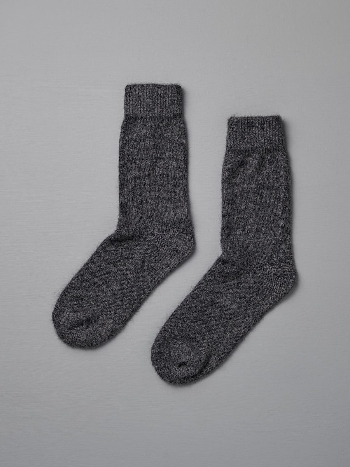Francie&#39;s Possum Merino Socks in Charcoal, available in small, medium, and large sizes, are shown side by side on a plain light gray background.