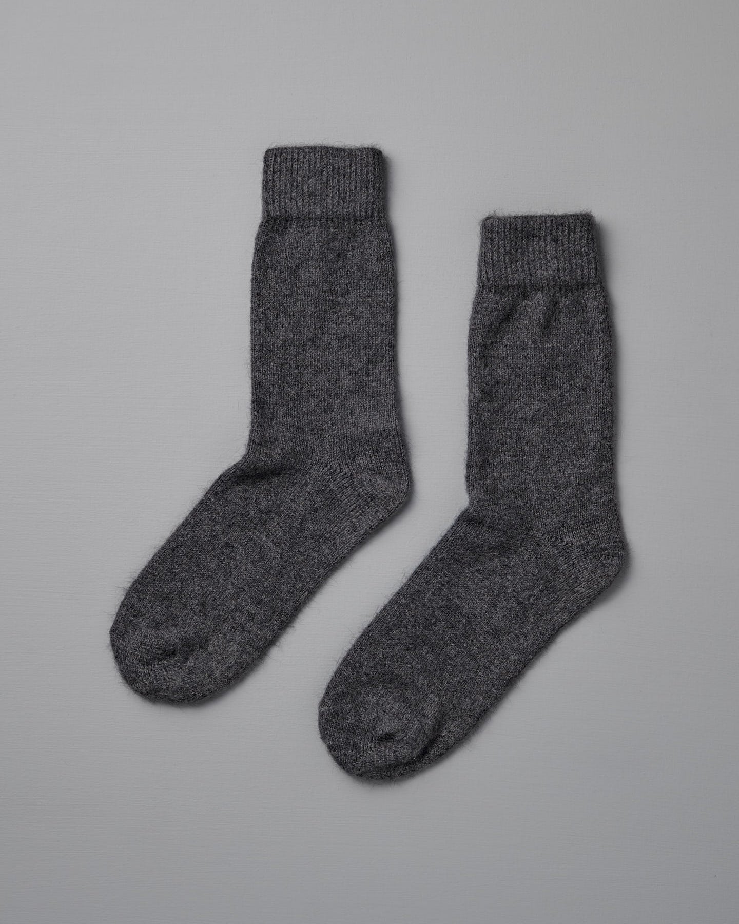 Francie's Possum Merino Socks in Charcoal, available in small, medium, and large sizes, are shown side by side on a plain light gray background.
