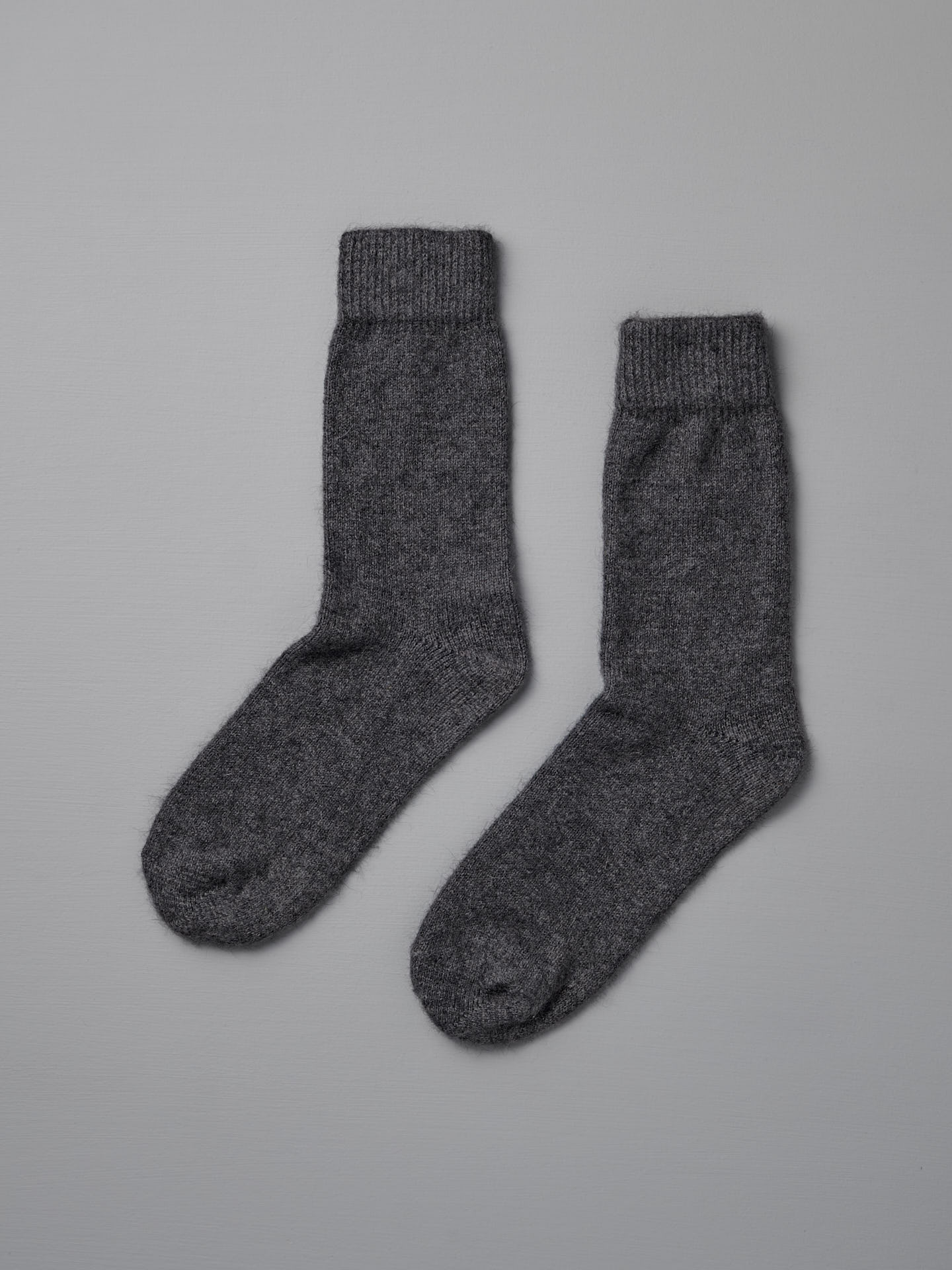Francie's Possum Merino Socks in Charcoal, available in small, medium, and large sizes, are shown side by side on a plain light gray background.