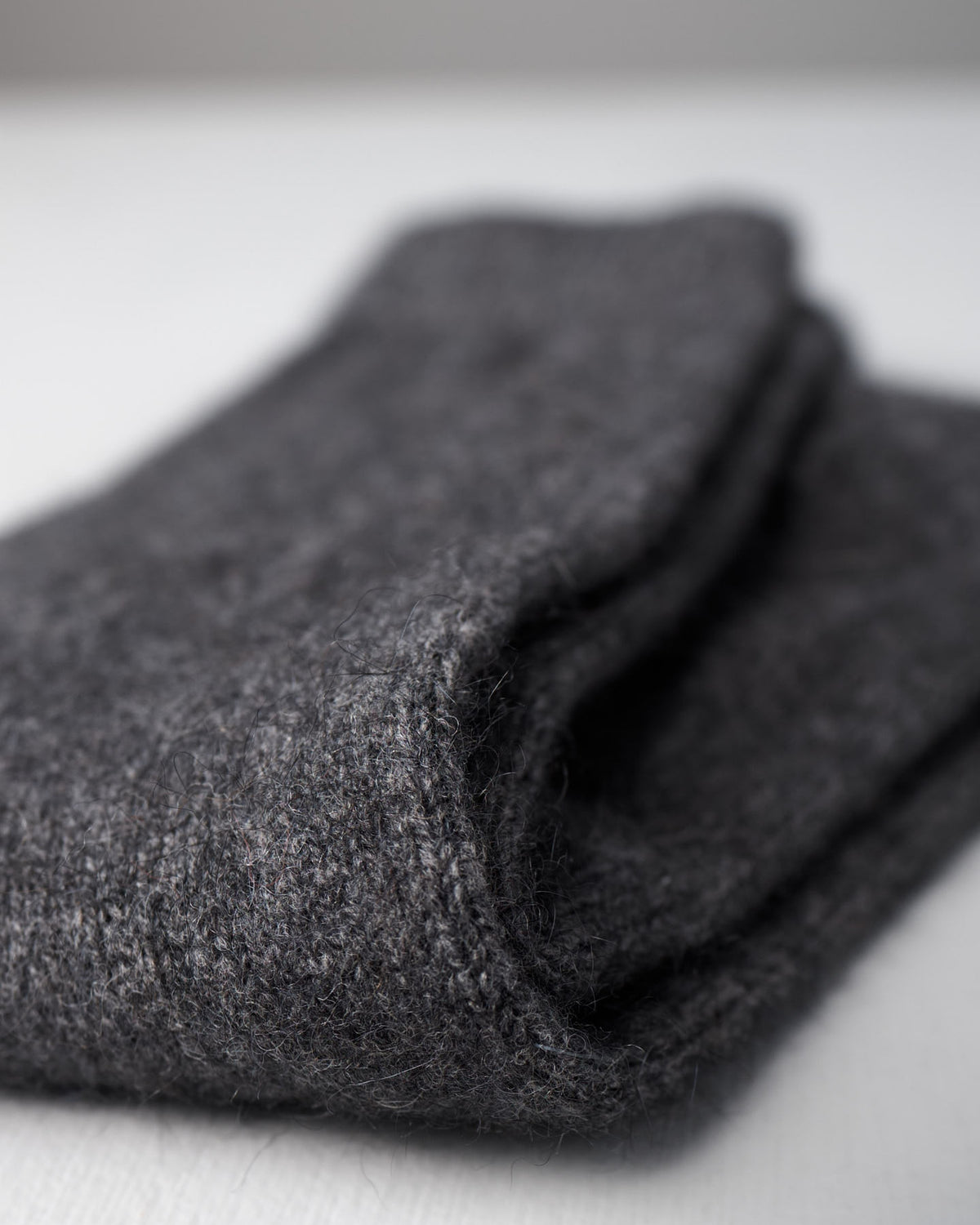 A close-up of Francie's Possum Merino Socks in Charcoal on a white surface, available in small, medium, and large. The perfect addition to any outfit—see our UK US EUR size guide for your best fit.