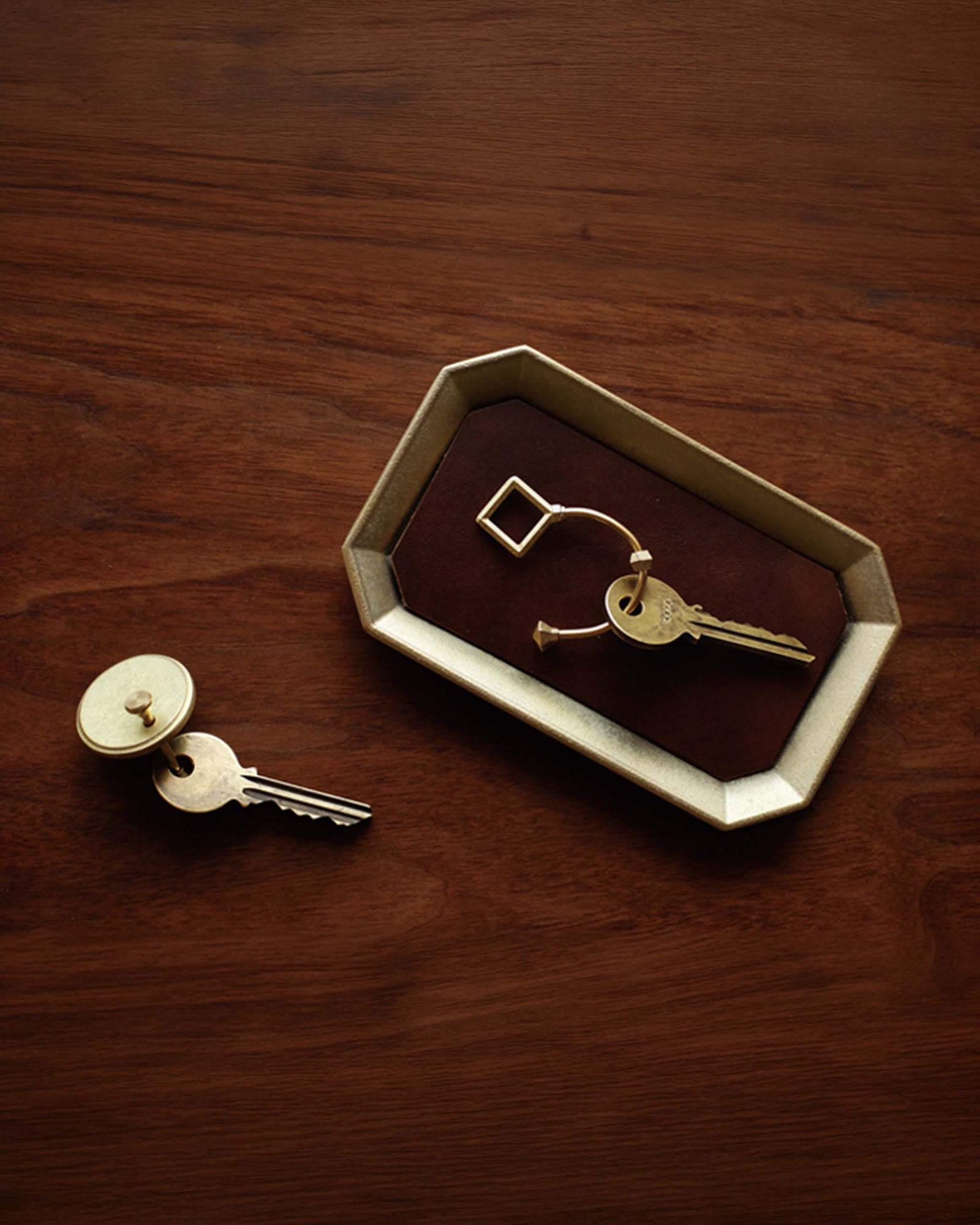 A Futagami Stationery Tray - Solid Brass with a pen and a pen holder.