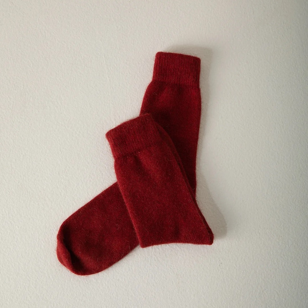 A single Possum Merino Socks - Crimson designed for various shoe sizes laid flat on a white background. Brand name: Francie.