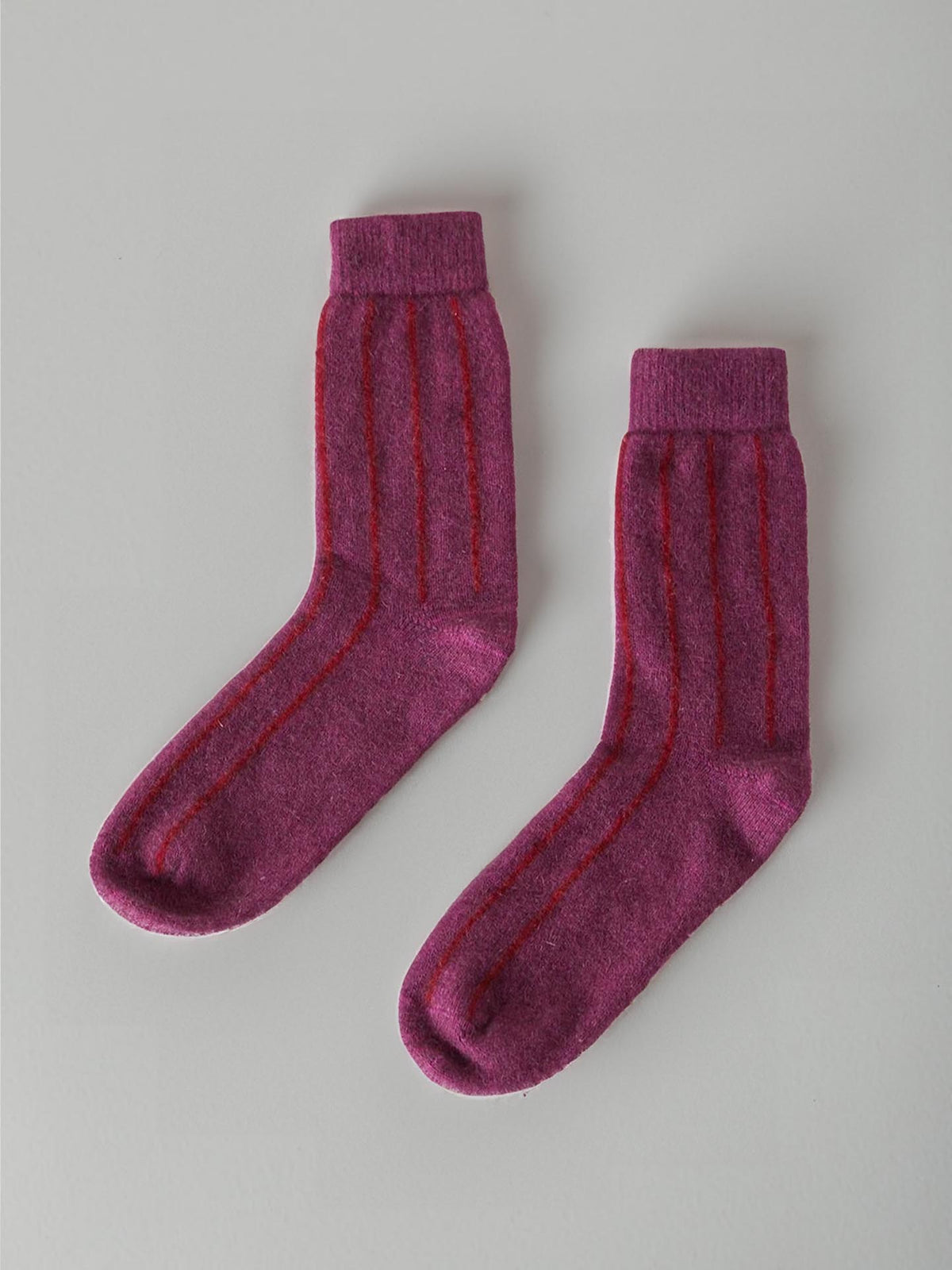 A pair of Francie Possum Merino Socks in Orchid &amp; Poppy Stripe, displayed on a light grey background.