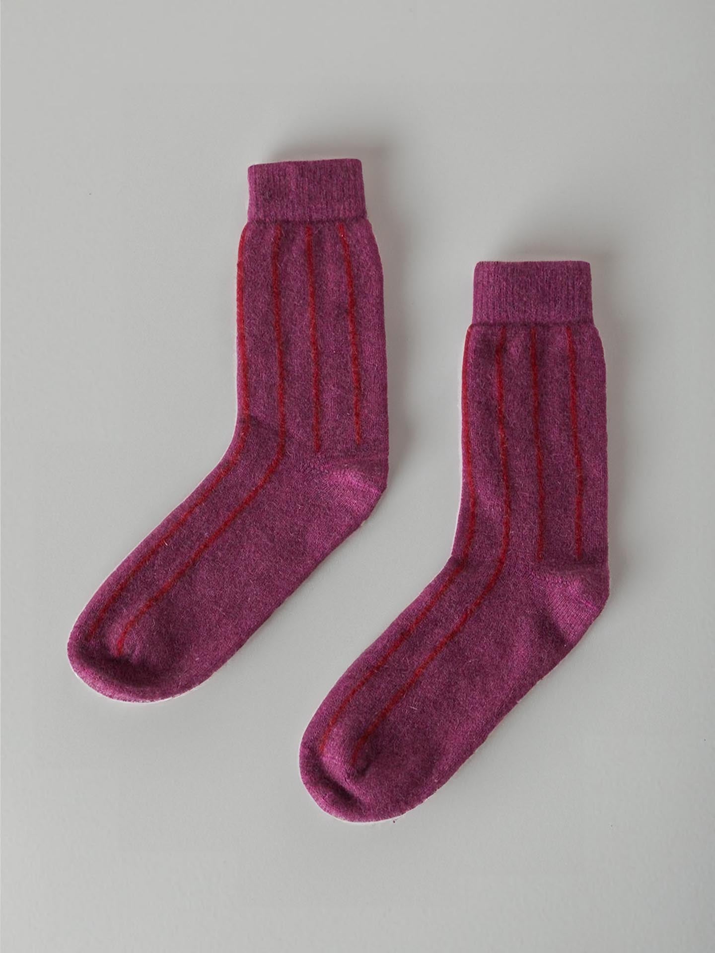 A pair of Francie Possum Merino Socks in Orchid & Poppy Stripe, displayed on a light grey background.