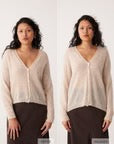 Petite woman with long curly hair wearing the Mist Cardigan in Creme and a dark brown skirt, standing against a plain white background in two similar poses.