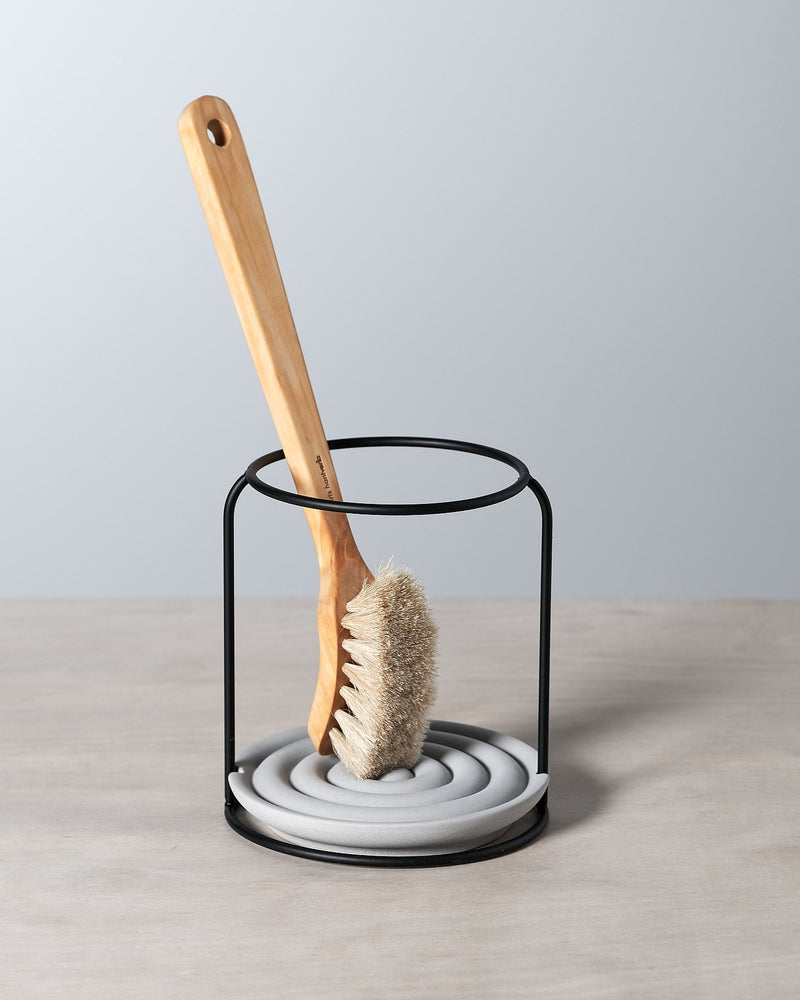 An Iris Hantverk dish brush holder on a table.