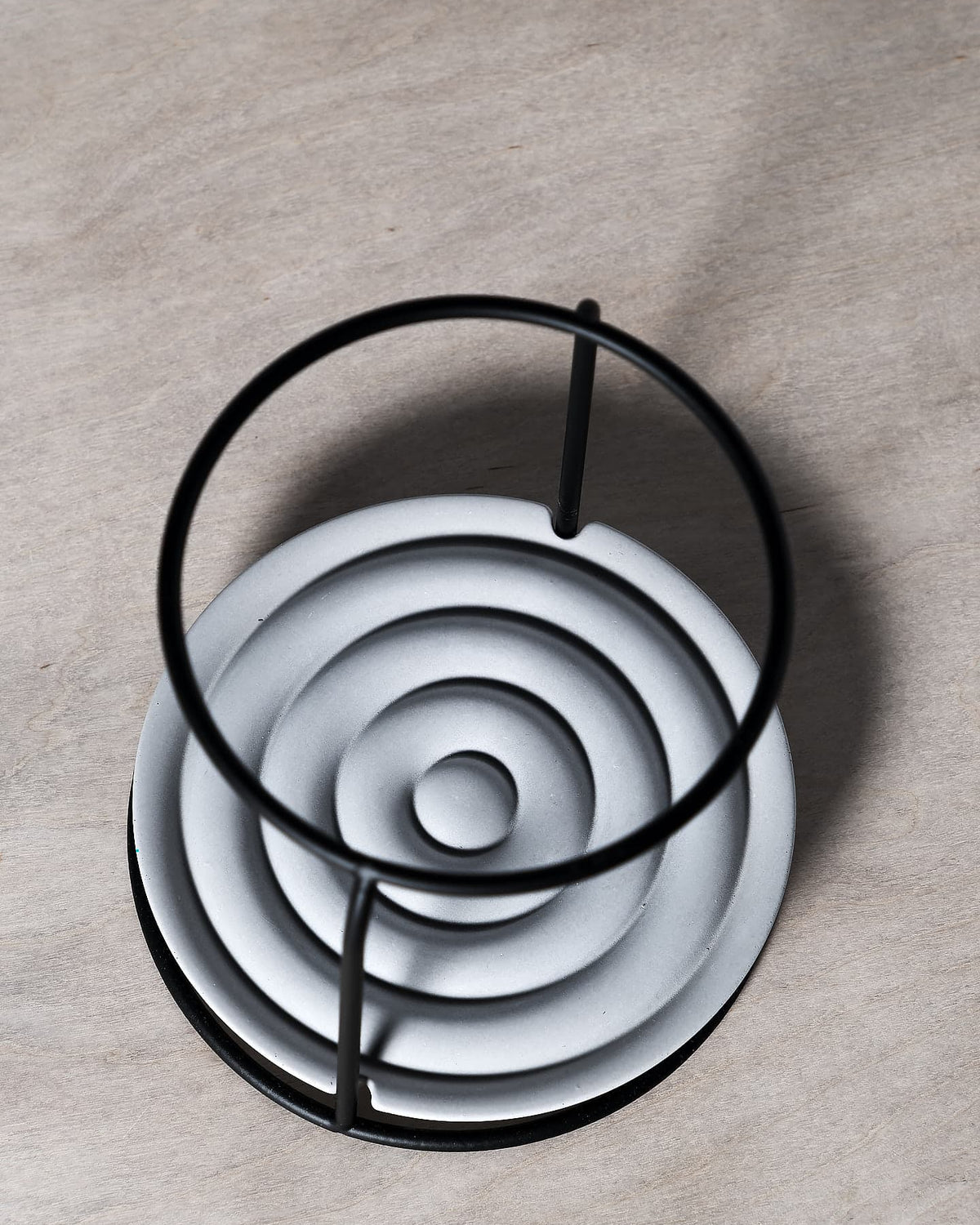 An Iris Hantverk dish brush holder on a wooden surface.