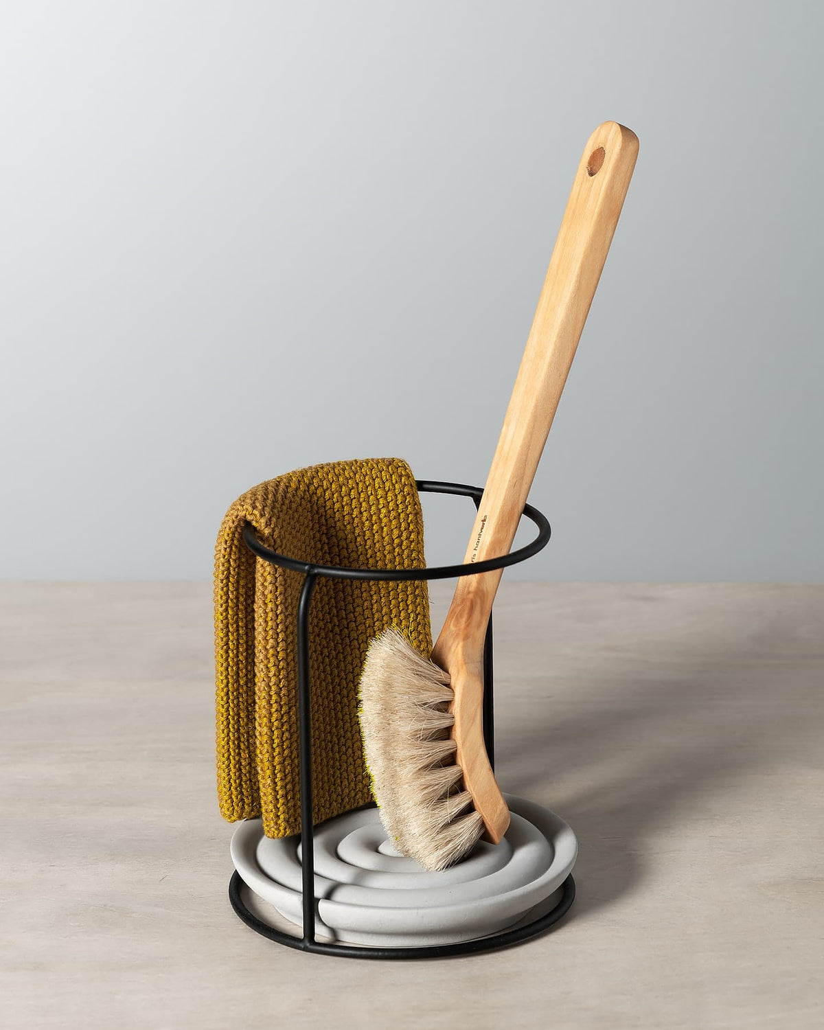 A Dish Brush Holder with a mustard colour cloth and wooden brush, all by Iris Hantverk.