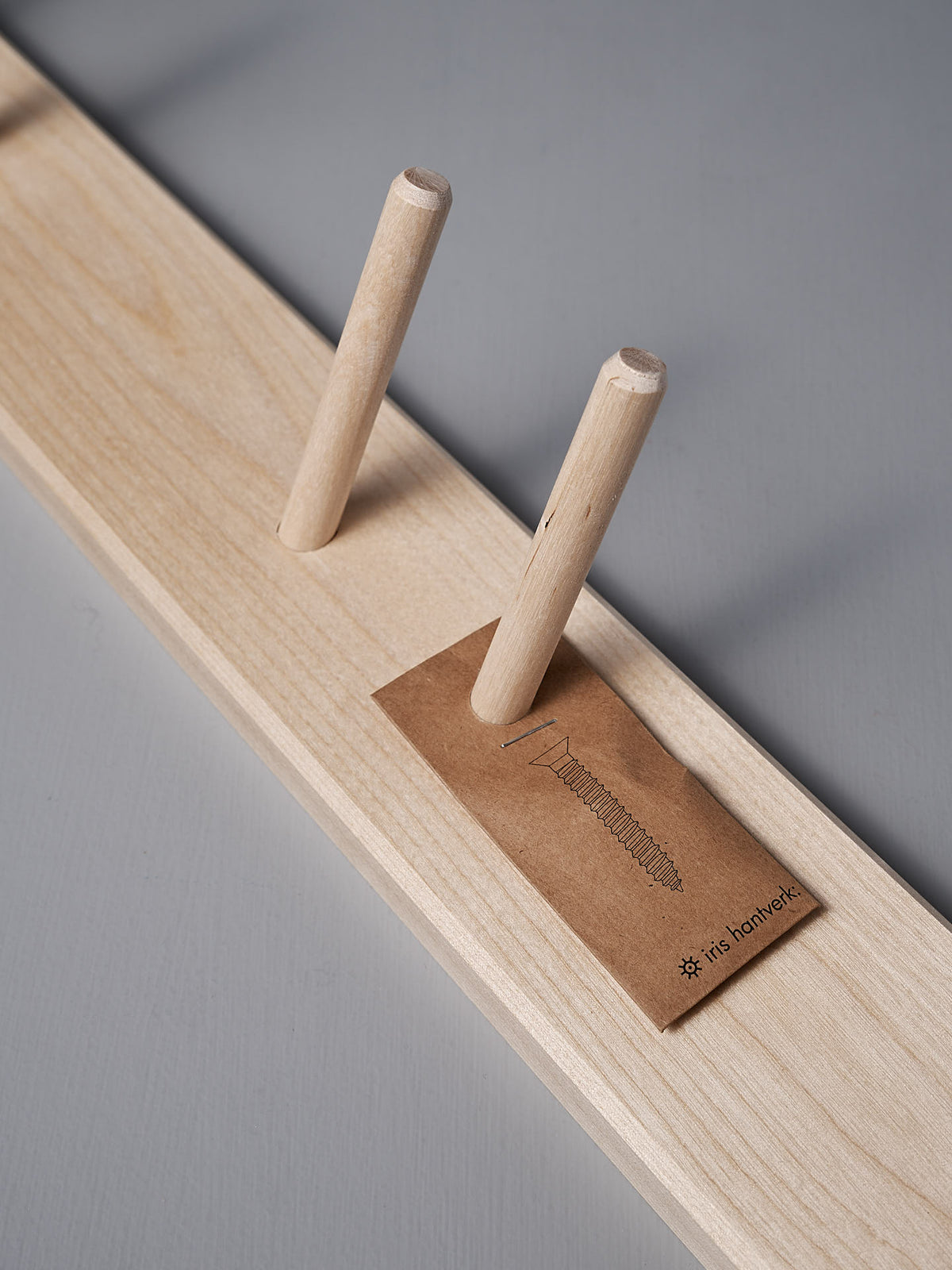 Birchwood Garden Tool Hanger by Iris Hantverk, featuring two vertical dowels and a small card labeled &quot;It&#39;s Handmade,&quot; highlighting its Shaker-inspired design.