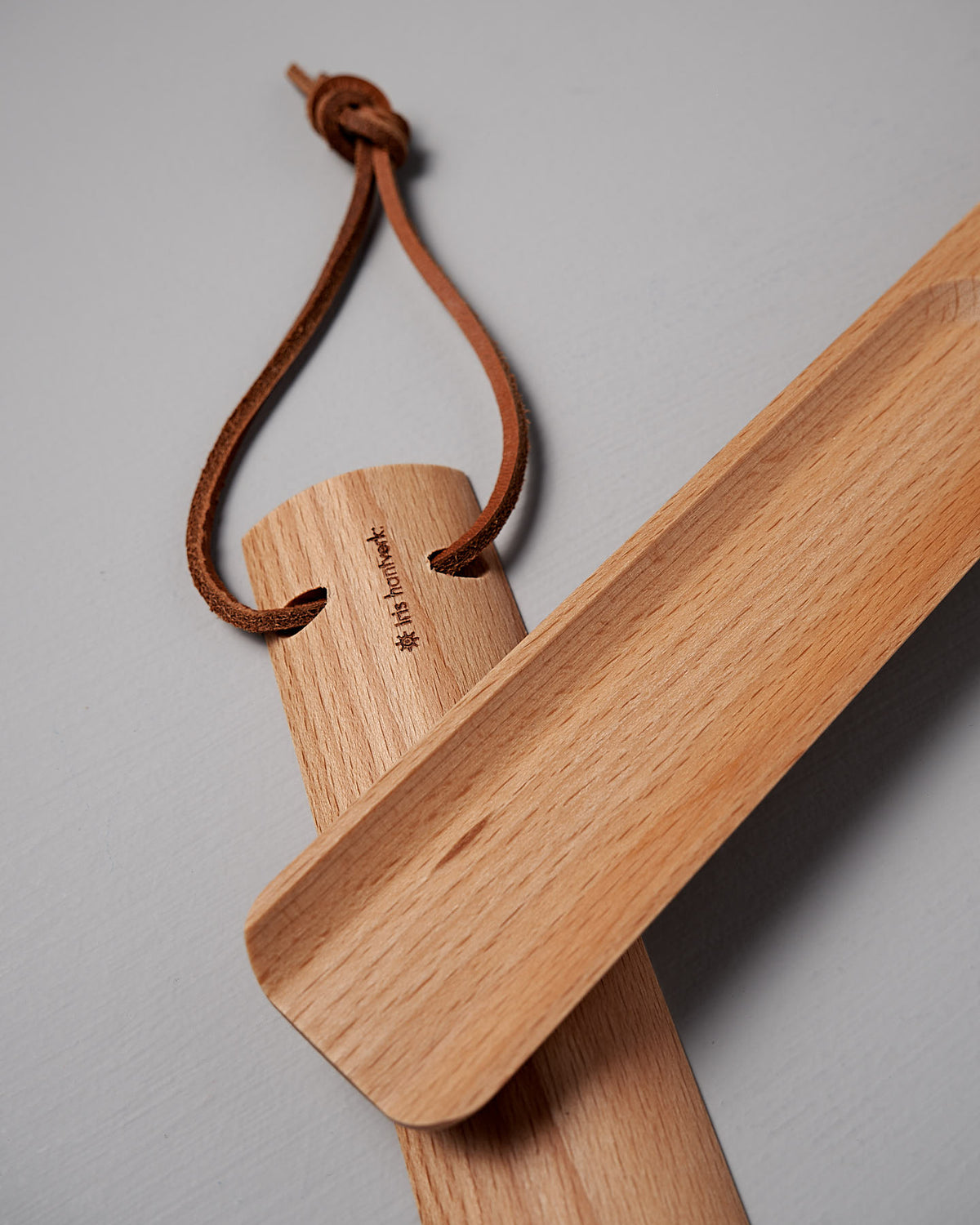 The Iris Hantverk Shoe Horn – Short ⋄ Long, made from oiled beech, includes a handy leather loop for hanging.