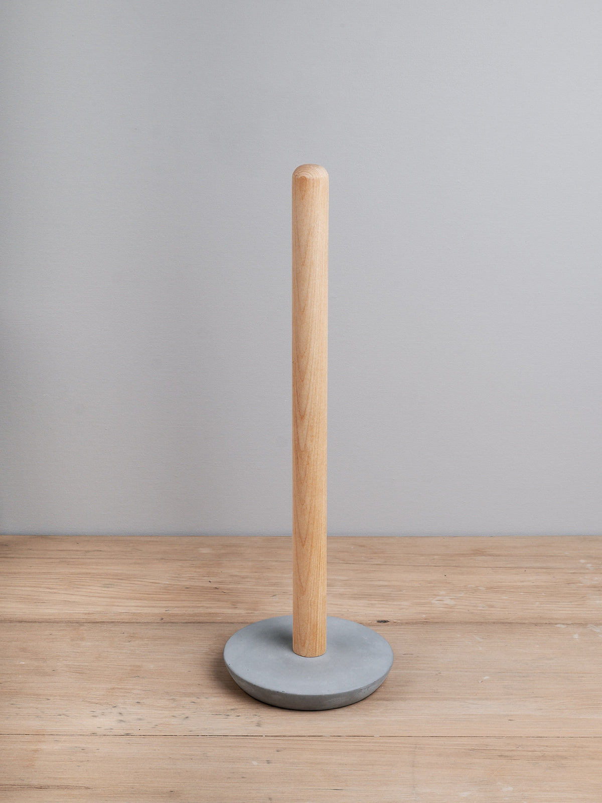 A wooden Iris Hantverk Toilet Brush + Toilet Roll Holder Set standing upright on a gray base against a neutral background.