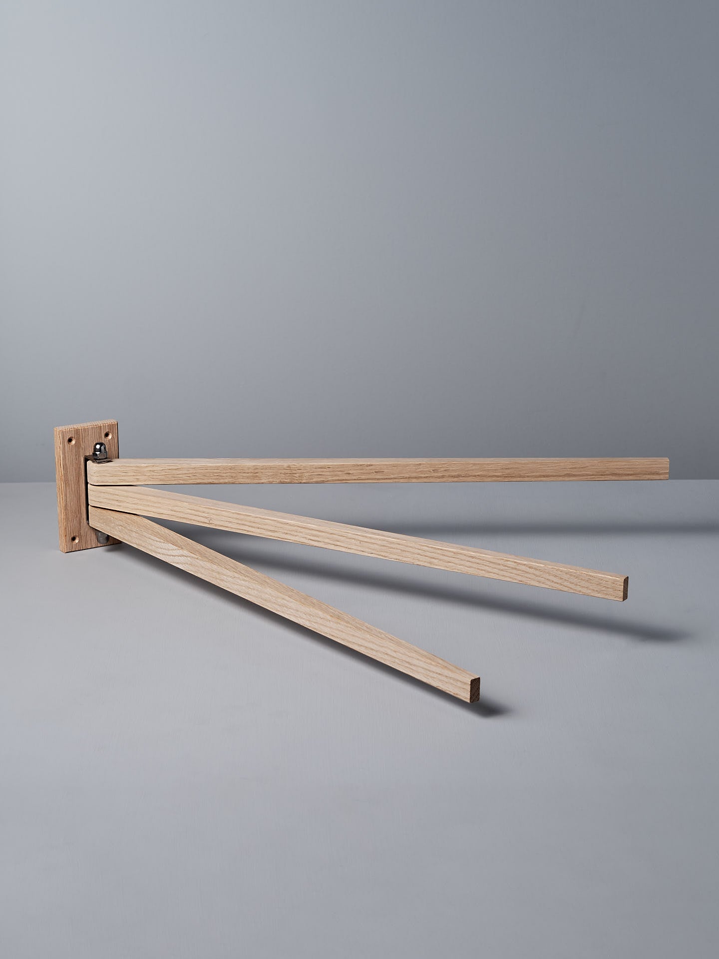 The Oak Towel Drying Rack – 3 Arm by Iris Hantverk showcases an elegant design with three outward-extended horizontal arms, crafted from fine oak to add a touch of natural beauty.