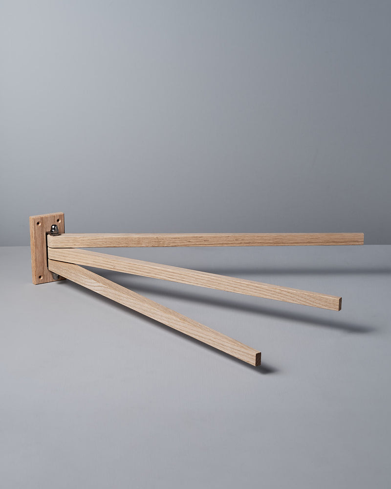 The Oak Towel Drying Rack – 3 Arm by Iris Hantverk showcases an elegant design with three outward-extended horizontal arms, crafted from fine oak to add a touch of natural beauty.