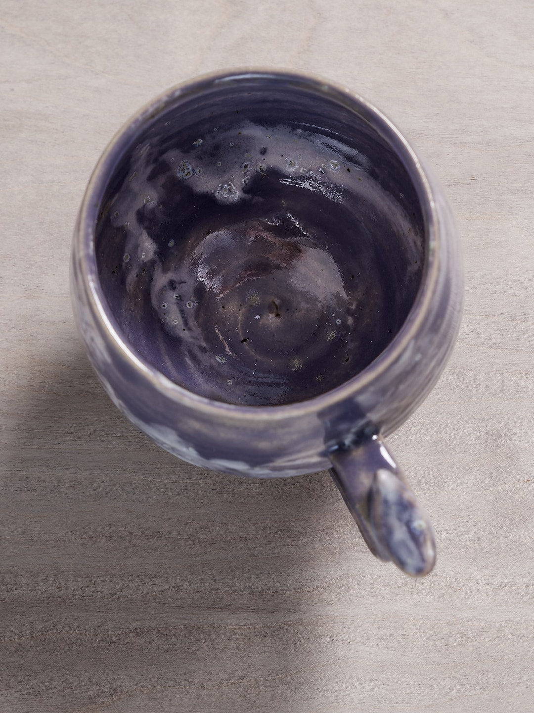 A Jino Ceramic Studio Bird Handle Cup - Pukeko on a wooden table.