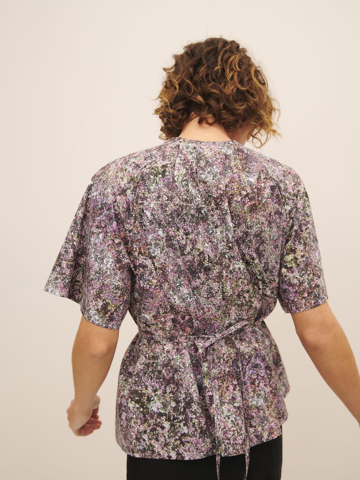 Person from behind wearing a Kowtow Etude Top – Bouquet with an oversized fit.