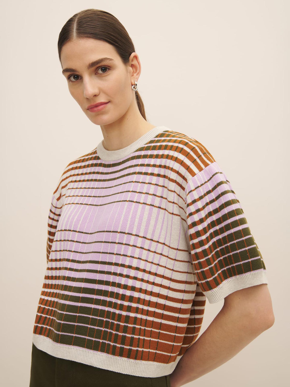 Woman in a Kowtow Gradient Knit Top looking at the camera.