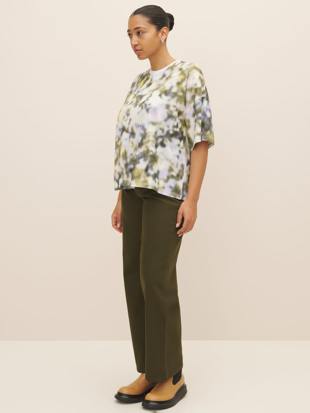 The model is wearing a Komorebi Print Tee from Kowtow with an oversized fit.