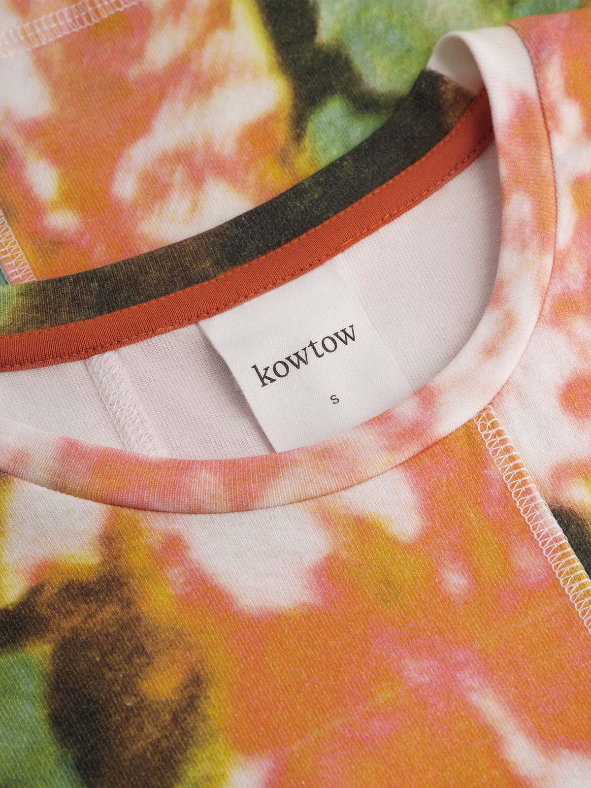 Close-up of the Montage Tee – Flower Book by Kowtow, showcasing its multicolored abstract floral pattern, visible stitching around the collar and label, and relaxed fit for effortless style.