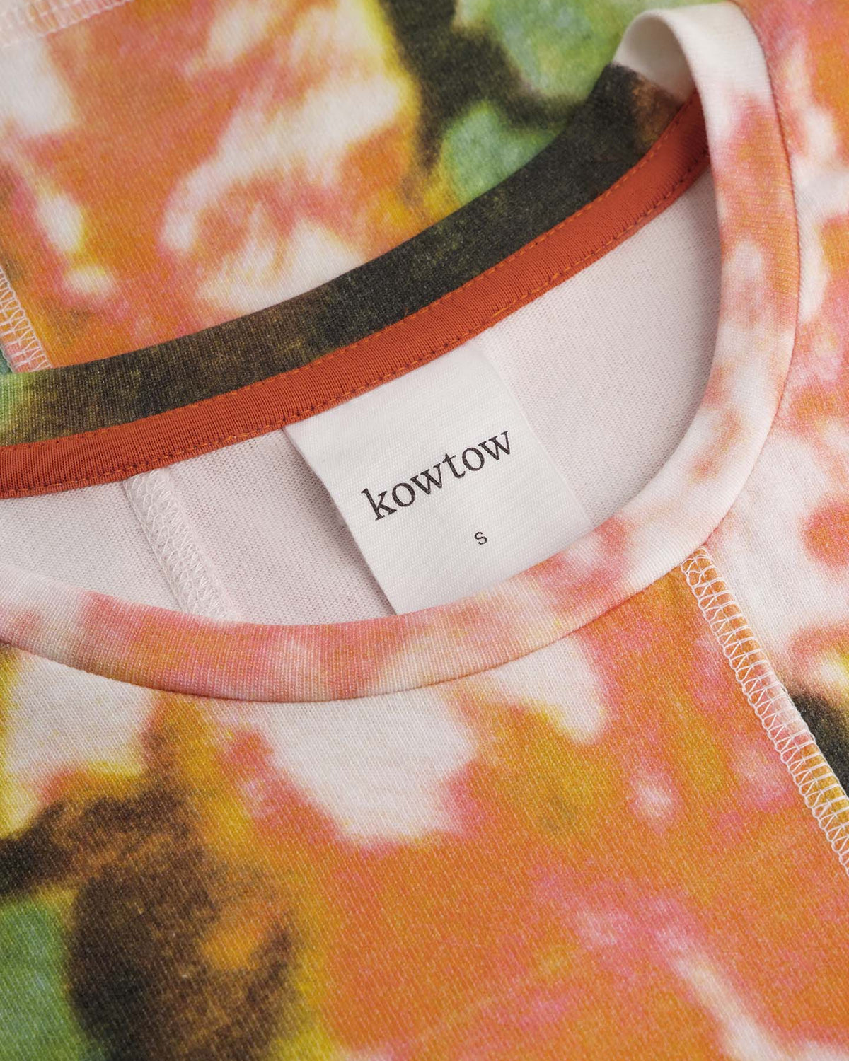 Close-up of the Montage Tee – Flower Book by Kowtow, showcasing its multicolored abstract floral pattern, visible stitching around the collar and label, and relaxed fit for effortless style.