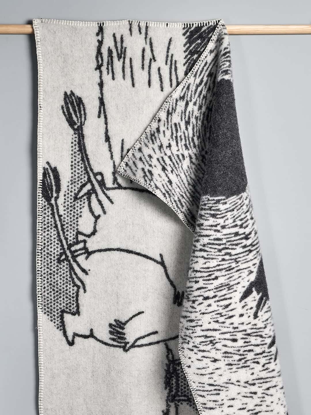 A black and white Moomin Childs Blanket – Camp Adventure with an image of a moose on it.