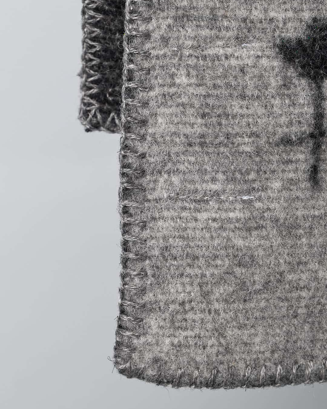 A Klippan Moomin Baby Blanket – Tree Hug with a cross on it.