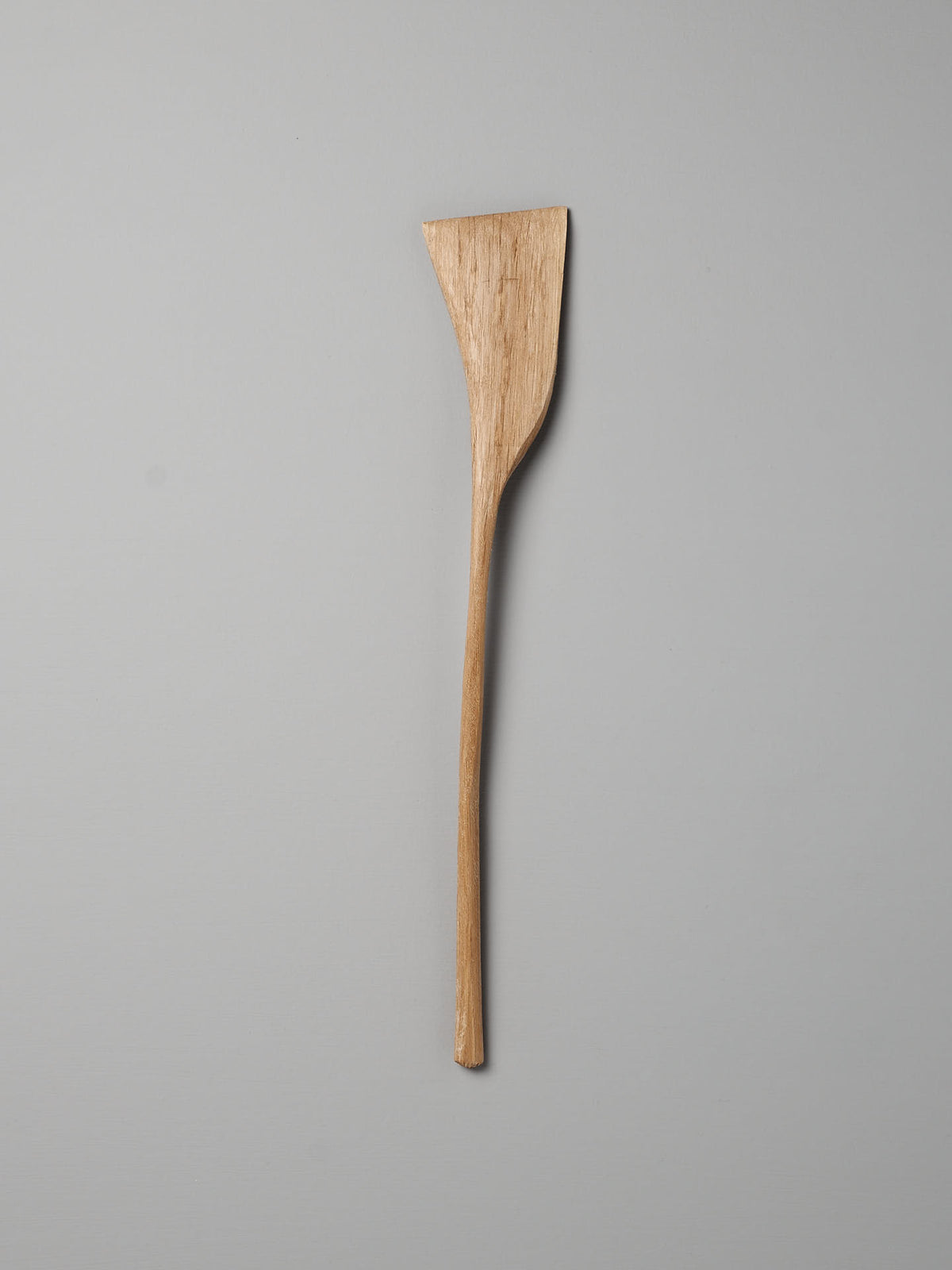 A single Luke Crouch Sauté Tool, hand-carved from Australian She-Oak with a rectangular head, displayed against a plain grey background.