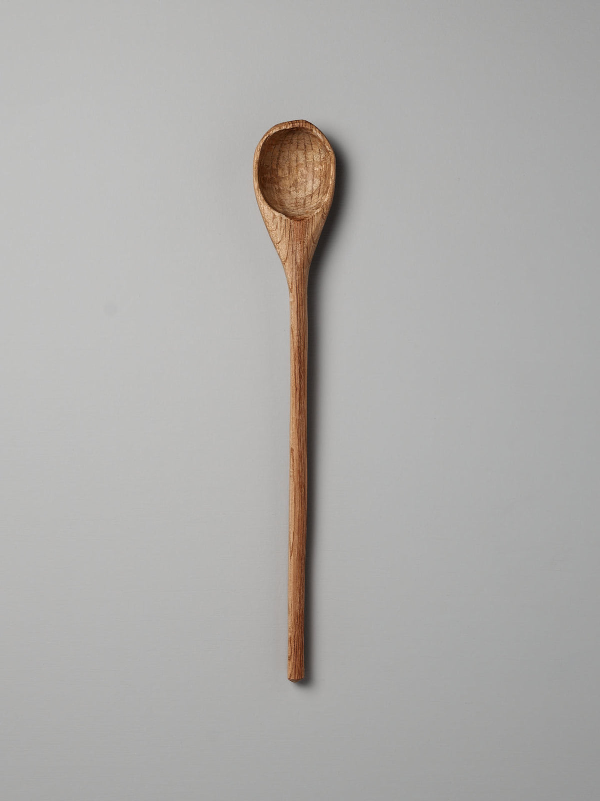 The Straight Ladle by Luke Crouch is a distinctive kitchen tool, featuring a long handle and a shallow, round bowl crafted from Australian She-Oak and displayed against a plain gray background.