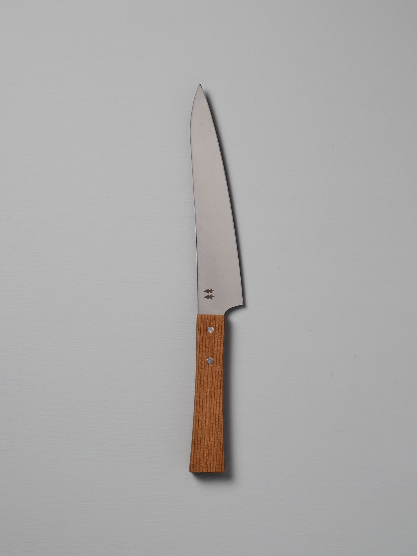 The Morinoki Ban Nou Knife by Shizu Hamono Co., featuring an ergonomic wooden handle and a razor-sharp blade, is set against a neutral background, highlighting its sleek and polished design.