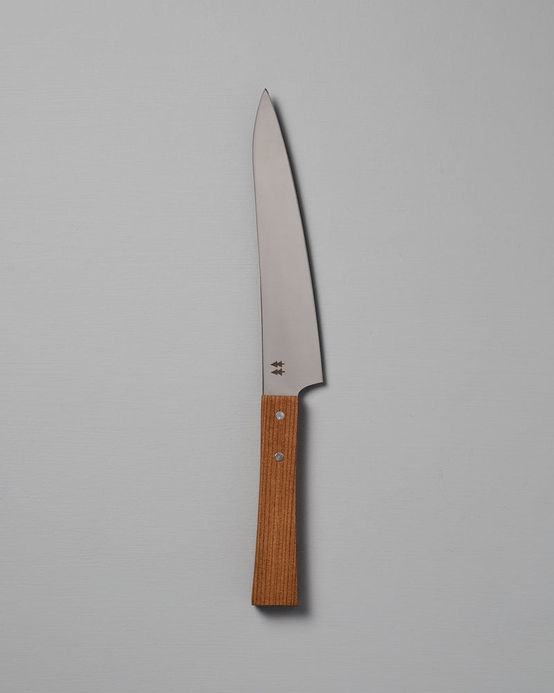 The Morinoki Ban Nou Knife by Shizu Hamono Co., featuring an ergonomic wooden handle and a razor-sharp blade, is set against a neutral background, highlighting its sleek and polished design.