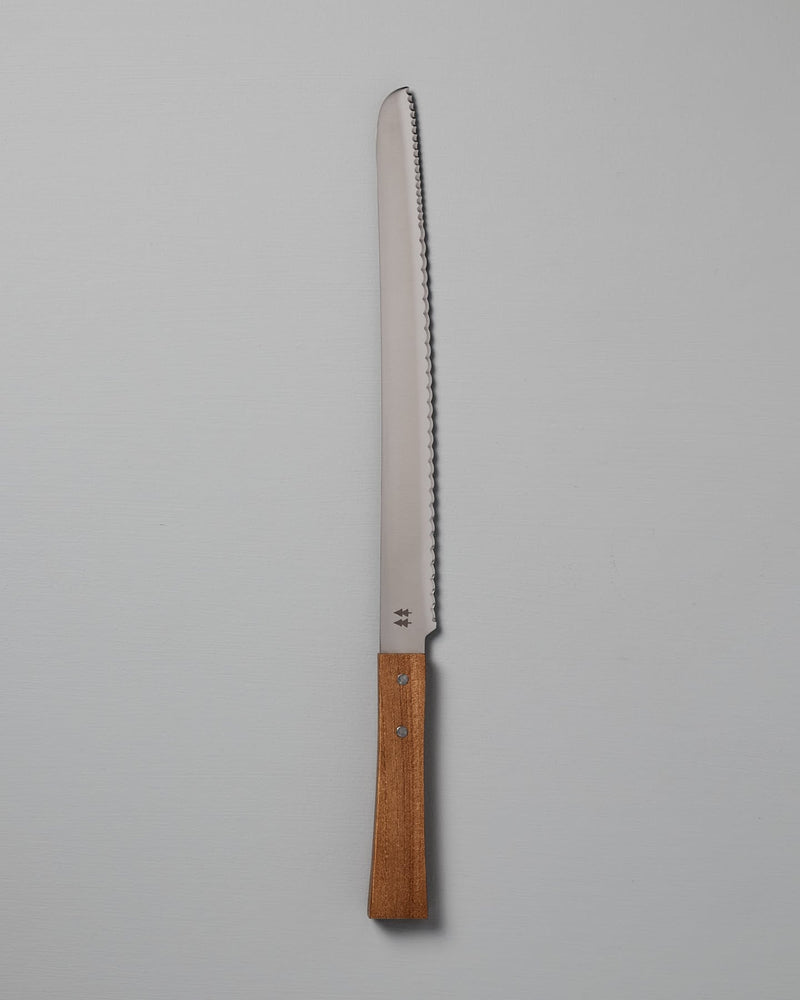 A Morinoki Bread Knife by Shizu Hamono Co., featuring a serrated stainless steel blade and a handle crafted from exquisite Japanese Zelkova wood, set against a plain white background.